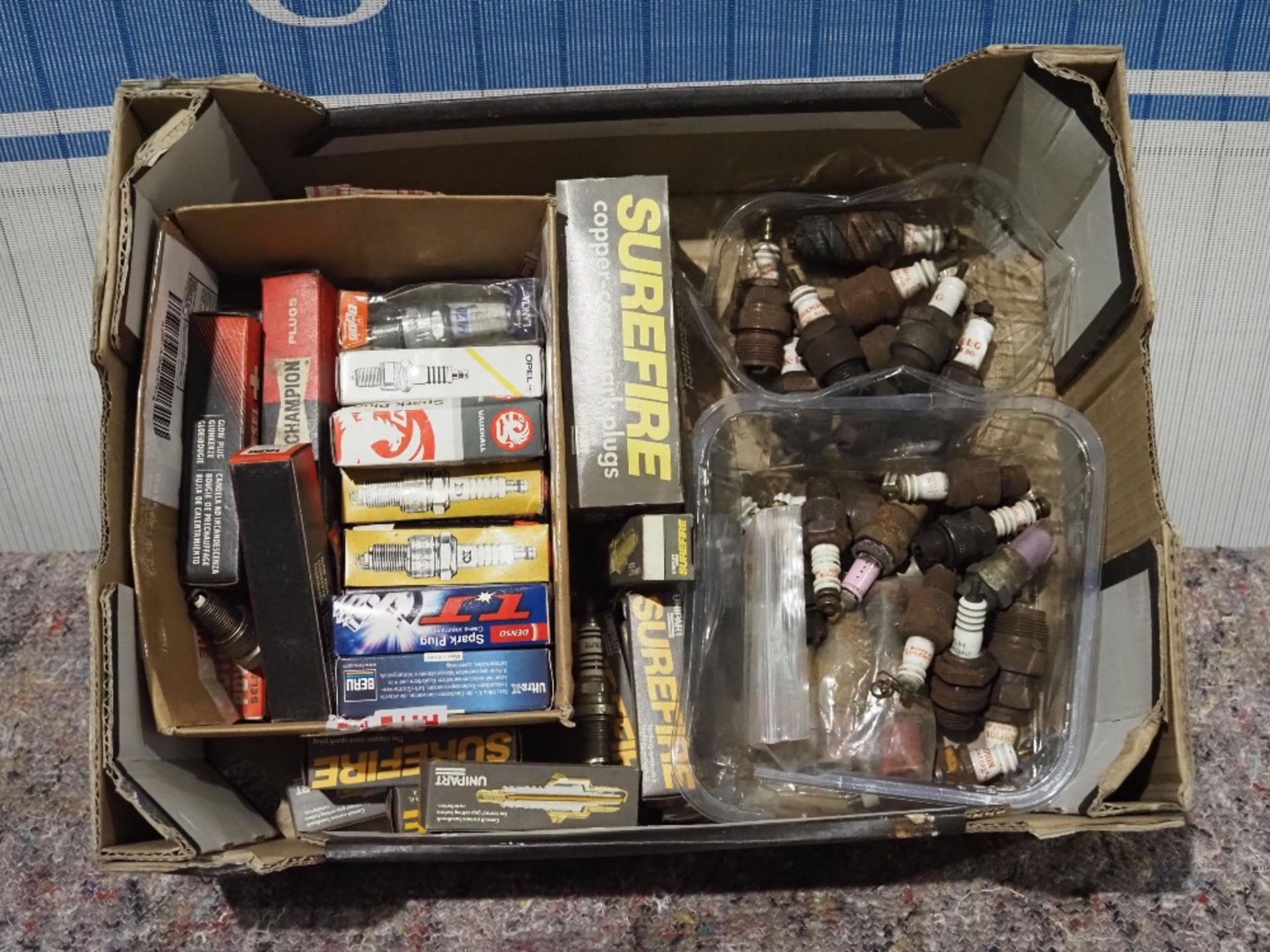 Box of assorted spark plugs