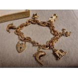 9ct Gold Charm Bracelet - a number of the charms are unmarked - total weight 17.9g