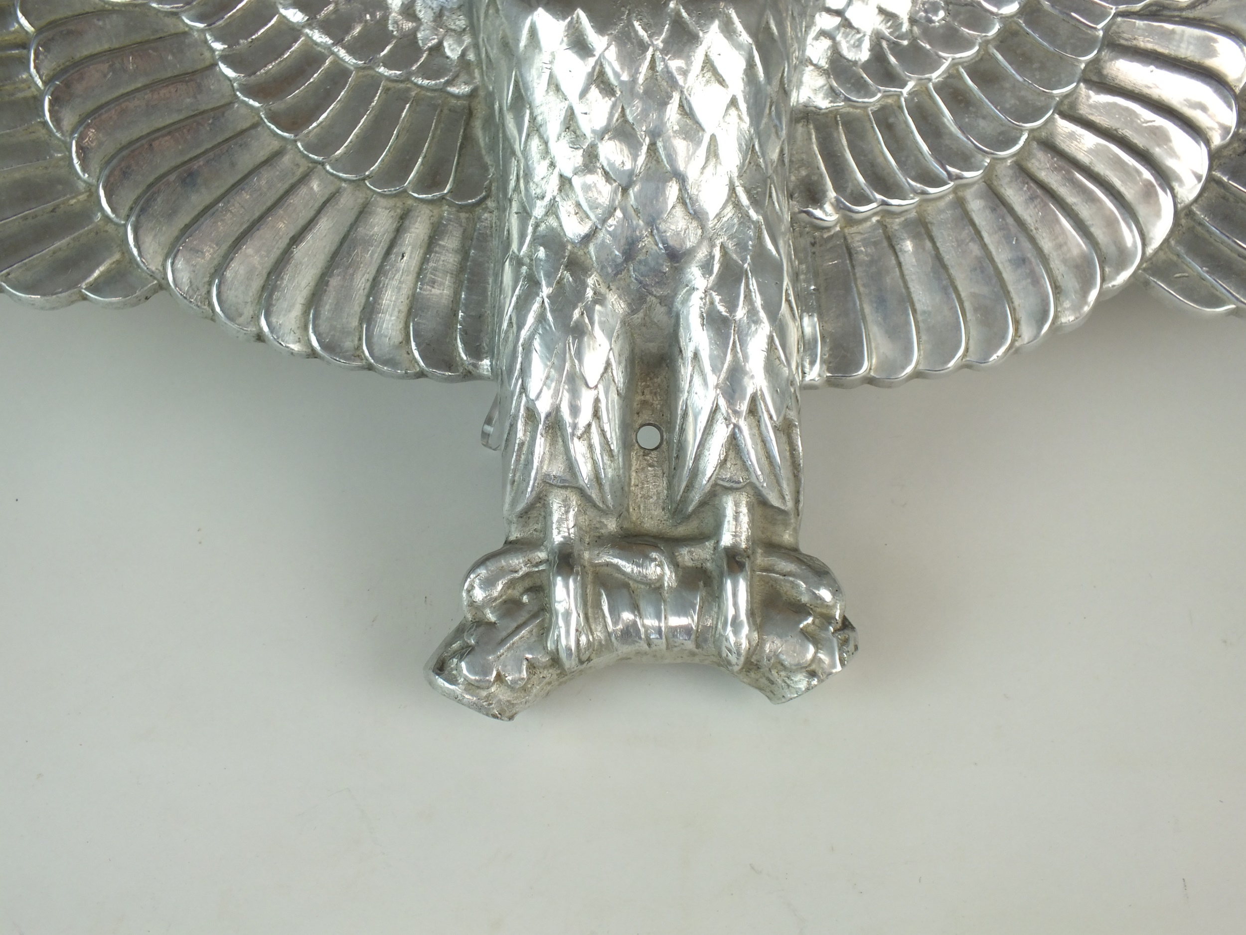 A De-Nazified German cast aluminium wall eagle, possibly post-war, 76cm wide Provenance and notes: - Image 2 of 3