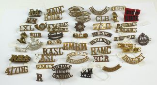 An assorted collection of military shoulder titles, some matched pairs, comprising approximately