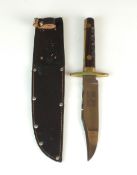 A William Rogers bowie knife, with finger grooves to the hilt and housed in original leather sheath,