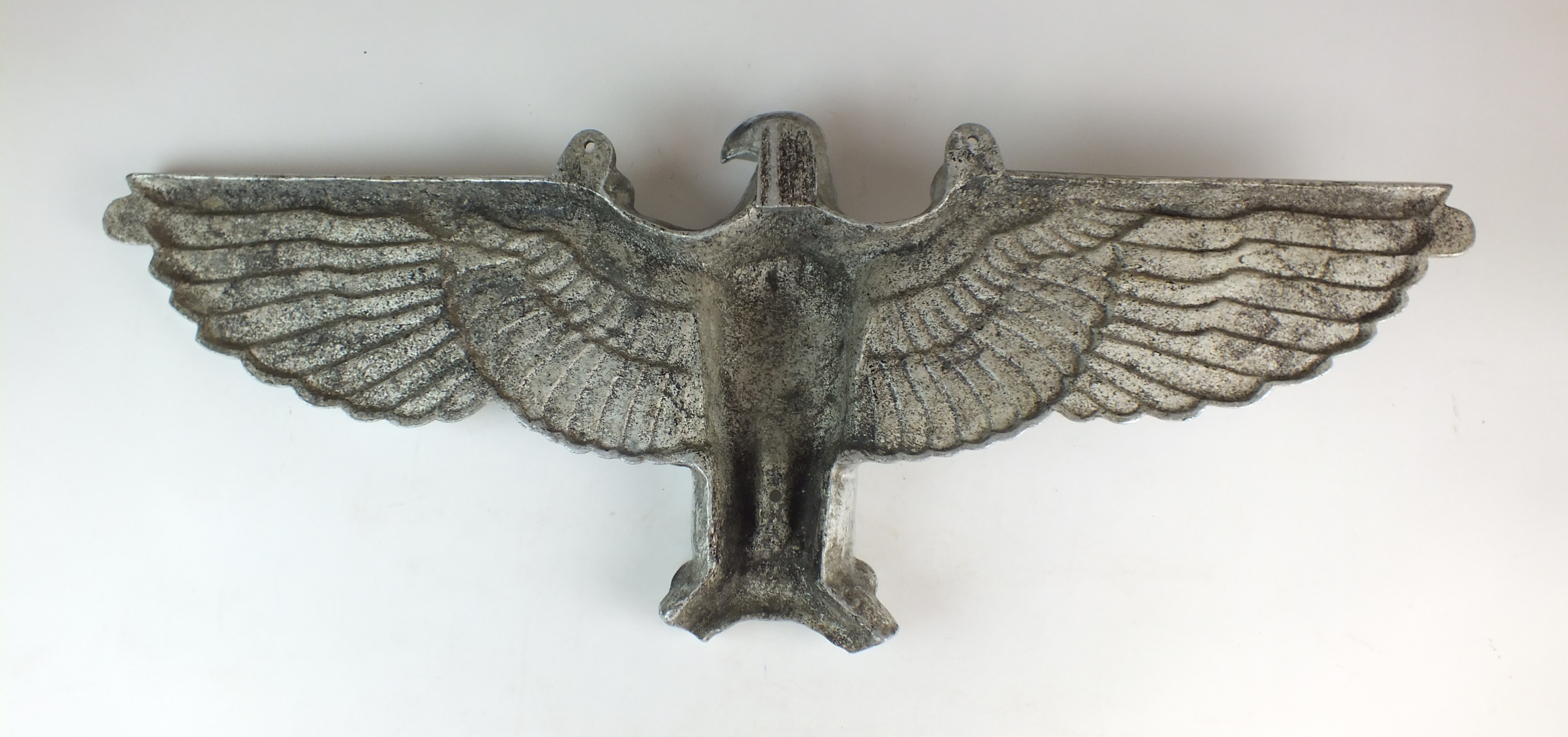 A De-Nazified German cast aluminium wall eagle, possibly post-war, 76cm wide Provenance and notes: - Image 3 of 3