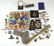 A group of assorted militaria including shoulder titles, sweetheart badges, medallions, ARP badge,