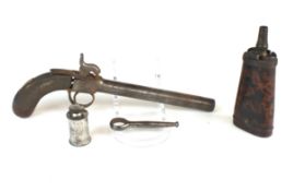 A pistol powder flask by Twigg, with barrel key, oil bottle and a percussion pistol