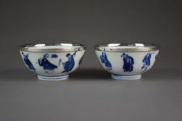 A pair of Chinese blue and white 'immortals' bowls, Kangxi marks and period