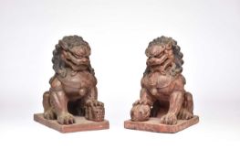 A pair of Chinese lacquered carved wood figures of guardian lions