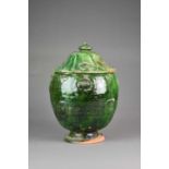 A Chinese green-glazed storage jar and cover, Ming Dynasty