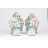 A pair of Chinese Famille Rose vases and covers