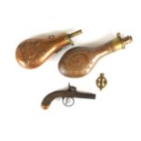 A percussion pocket pistol and two powder flasks