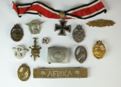 Thirteen reproduction post-war badges, medals and a belt buckle
