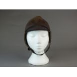 A British early leather Flying Helmet or Motoring helmet, probably WW1-era brown leather with wool-