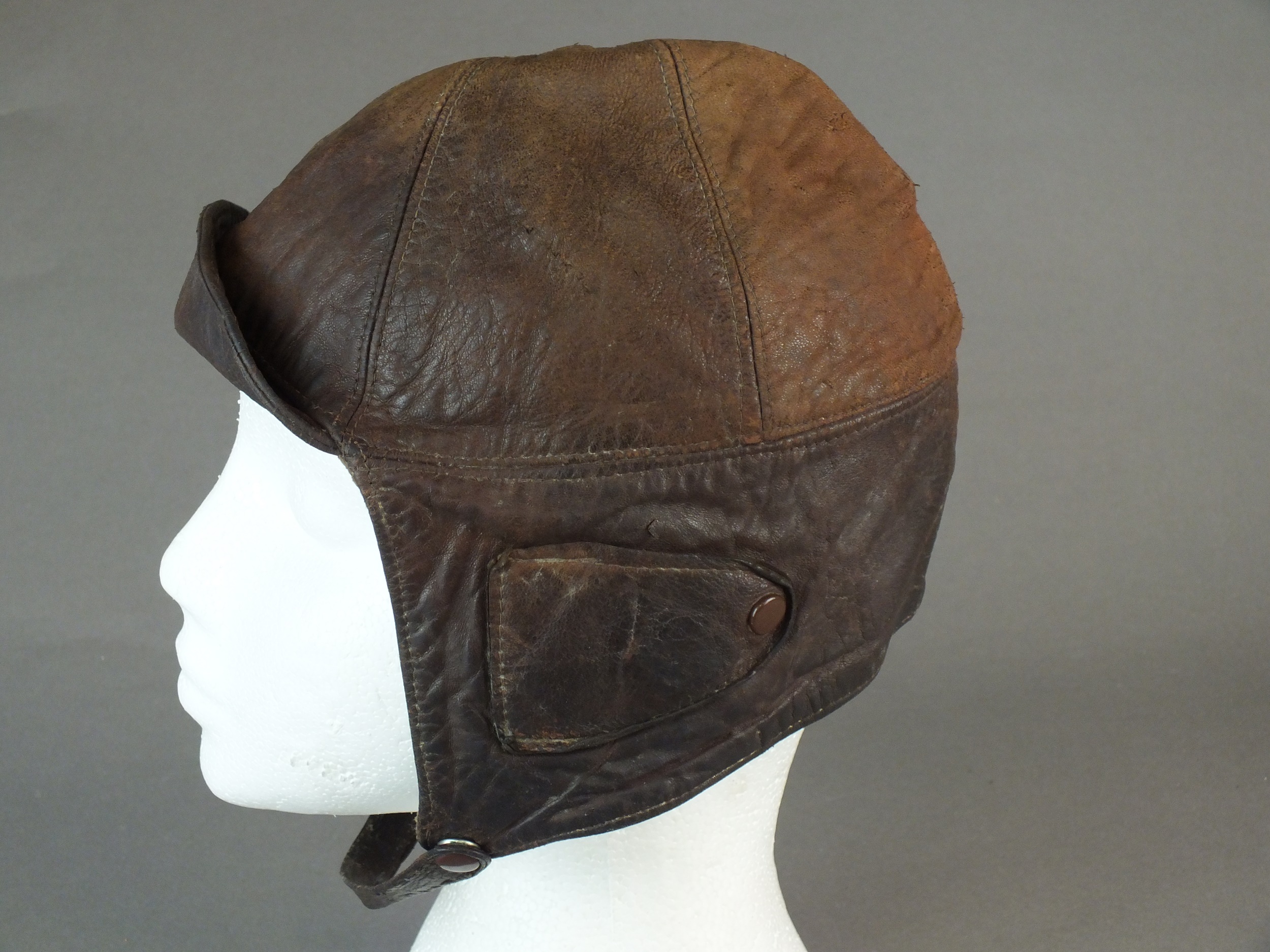 A British early leather Flying Helmet or Motoring helmet, probably WW1-era brown leather with wool- - Image 4 of 6