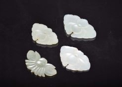 Four Chinese pale green jade pendants