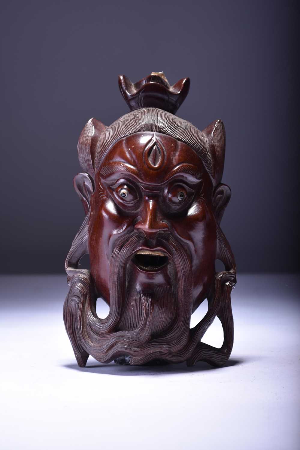 A South East Asian carved wood wall mask and a carved walnut shell - Image 2 of 3