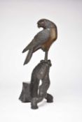 A Japanese bronze figure of an eagle perched on a branch