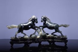 A pair of Chinese grey-green jade figures of horses, 20th century