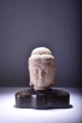 A carved sandstone head of Buddha, probably Gandhara