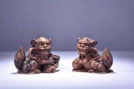 A pair of Chinese carved hardwood guardian lions, 20th century