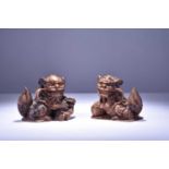 A pair of Chinese carved hardwood guardian lions, 20th century