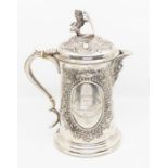 A late Victorian large silver presentation jug and cover, the body with two oval cartouches within
