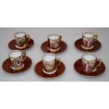 A set of six early 20th century Vienna porcelain coffee cans and saucers, each figurally decorated