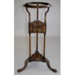 A George III mahogany wig stand, the dished top with moulded edge over triform stage fitted two
