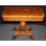 An early 19th century pollard oak card table, the crossbanded swivel folding top with beize