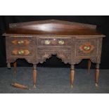 A 19th century Anglo- Indian carved padouk sideboard, the floral and beaded upstand over slight