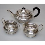 P and S, an Indian Stirling silver three piece tea service comprising pot with ebonized fittings,