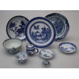 A group of Kangxi and other blue and white wares including a vase cover, tea bowl, two plates and