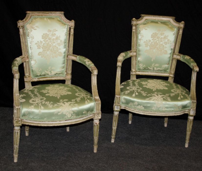 A pair of 19th century French open armchairs, each having caddy rail, padded bow back, overstuffed