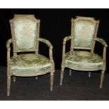 A pair of 19th century French open armchairs, each having caddy rail, padded bow back, overstuffed