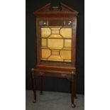 An Edwardian mahogany 'Chinese Chippendale' bookcase on stand, the broken architectural pediment