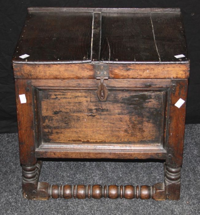 An 18th century oak bible box, the hinged plank top over panel sides with twin brass handles on