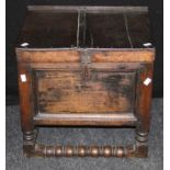 An 18th century oak bible box, the hinged plank top over panel sides with twin brass handles on