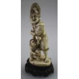 A late 19th/ early 20th century Japanese ivory carved figure of a man with a monkey and child,