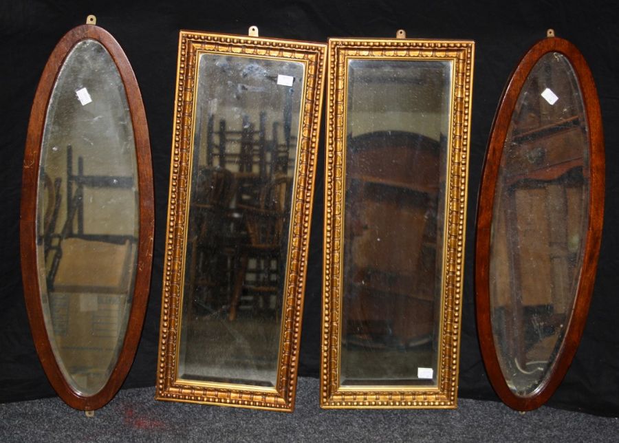 A pair of gilt composite wall mirrors, each with bevelled rectangular plate, 69 x 26cm and a pair of