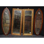 A pair of gilt composite wall mirrors, each with bevelled rectangular plate, 69 x 26cm and a pair of