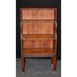 A 19th Anglo-Indian carved padouk waterfall bookcase of three open shelves, on fluted tapering