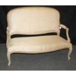 A 19th century French two person salon settee with upholstered open back and padded scrolled arms,