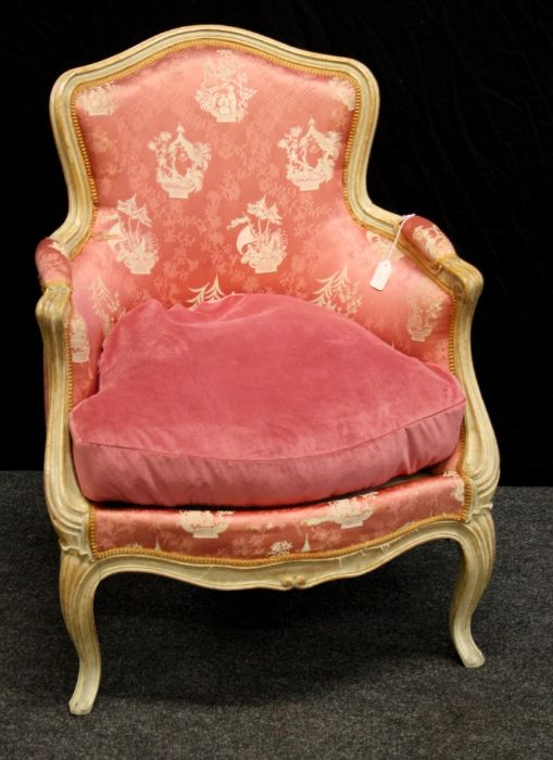 A 19th century French salon armchair with serpentine rail, padded back and downswept arms, sprung