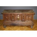 A late 18th century walnut cassone, the moulded edge rising top over florally relief carved panel