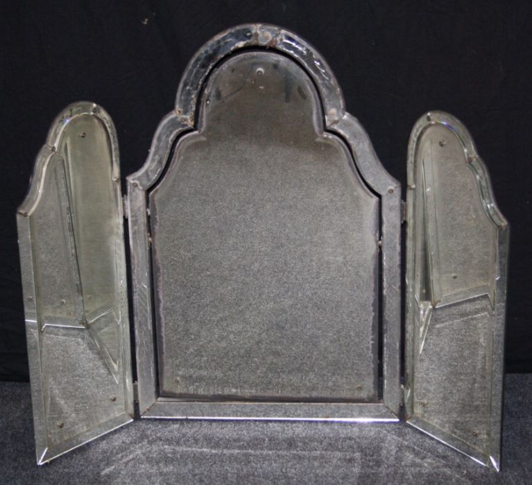 An early 20th century Venetian glass triple fold toilet mirror with swept arched bevelled plates and