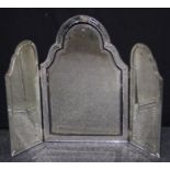 An early 20th century Venetian glass triple fold toilet mirror with swept arched bevelled plates and
