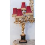 A pair of early to mid 20th century French four branched candlesticks, converted for electricity,