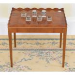 A small Edwardian mahogany and burr walnut side table, pie-crusted gallery raised on tapering