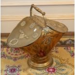 A brass coal scuttle, carrying handle with two opening lids, on a circular stepped base 57cm H x