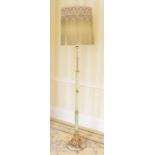 A mid 20th century floor lamp, gilt ad onyx column terminating with an ornate base, raised on a