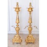 Two large early to mid 20th century gilt metal lamp columns, swag designs, each raised on three