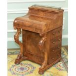 An early Victorian burr walnut Davenport desk, circa 1850, three quarter brass pierced gallery,